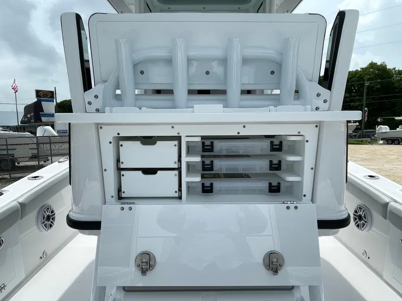 Slide: The Image of 2026 Blackfin 262 HB boat storage compartments with rod holders and tackle boxes. - 30