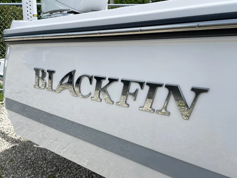 Slide: The Image of 2026 Blackfin 262 HB boat logo on white hull, close-up view. - 5