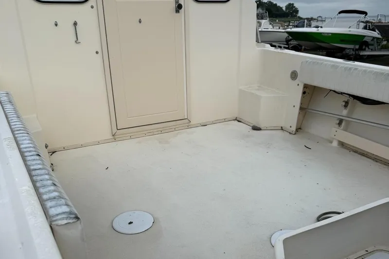 Slide: The Image of 2013 Parker 2120 SC boat interior with clean deck and seating. - 3