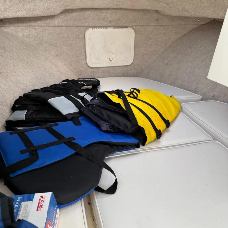 Slide: The Image of Life jackets inside a 2013 Parker 2120 SC boat cabin. - 7