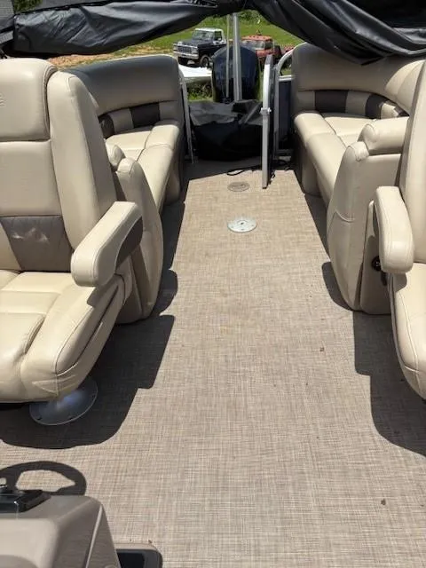 Slide: The Image of 2022 Sun Tracker Party Barge 22 XP3 interior with beige seating and spacious layout. - 10
