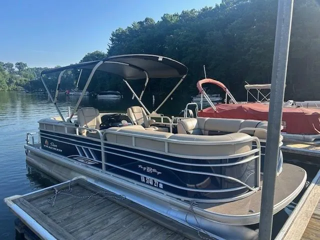 Slide: The Image of 2022 Sun Tracker Party Barge 22 XP3 pontoon boat docked by a scenic lake. - 13