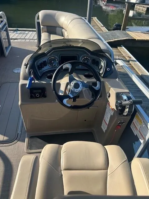 Slide: The Image of 2022 Sun Tracker Party Barge 22 XP3 helm with beige seating and control panel. - 17