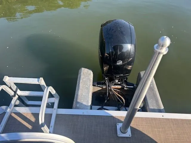 Slide: The Image of 2022 Sun Tracker Party Barge 22 XP3 with outboard motor on calm water. - 19