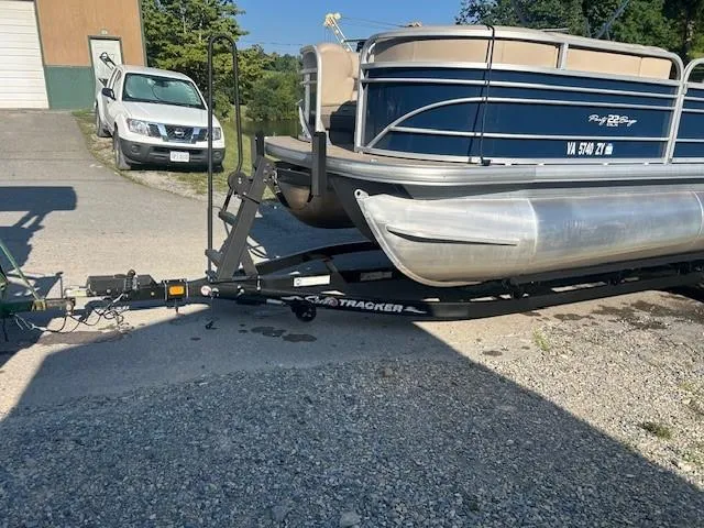 Slide: The Image of 2022 Sun Tracker Party Barge 22 XP3 on trailer, parked outdoors. - 23