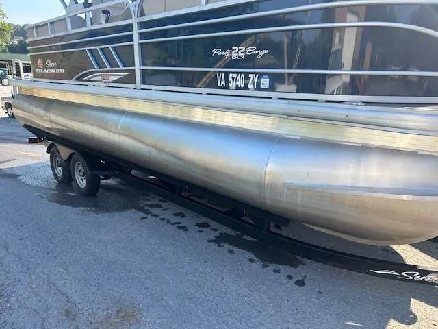Slide: The Image of 2022 Sun Tracker Party Barge 22 XP3 pontoon boat on trailer, side view. - 25