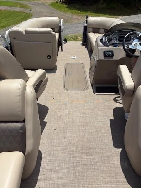 Slide: The Image of 2022 Sun Tracker Party Barge 22 XP3 interior with beige seating and steering console. - 6