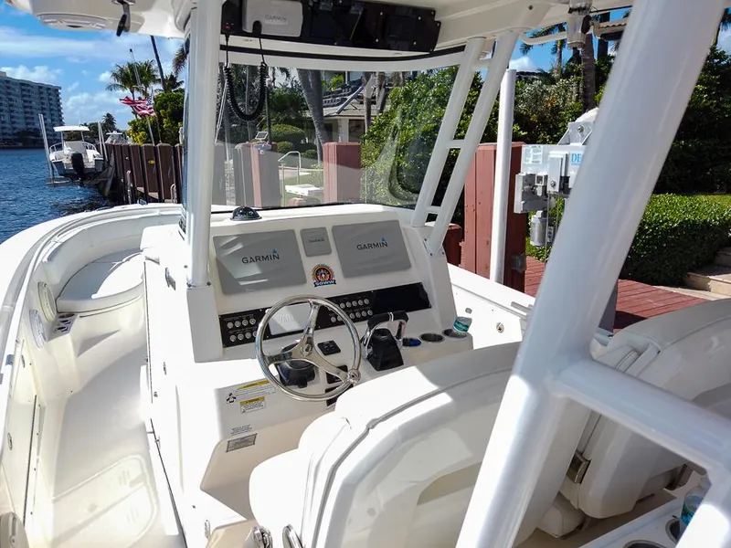 Slide: The Image of Edgewater 320CC 2015 boat cockpit with Garmin navigation, docked by waterfront. - 10