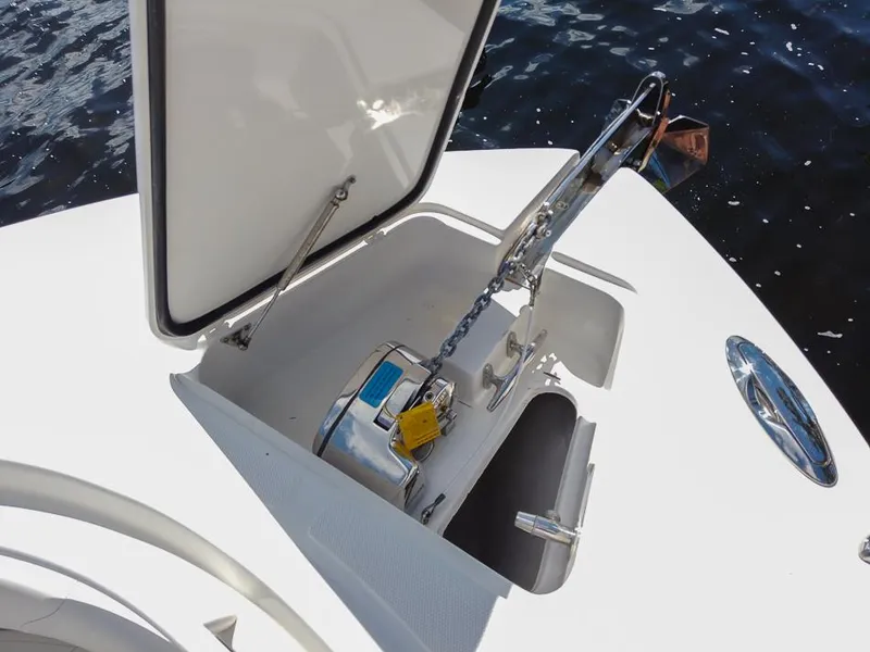 Slide: The Image of Open anchor compartment on 2015 Edgewater 320CC boat, showing anchor and chain mechanism. - 14