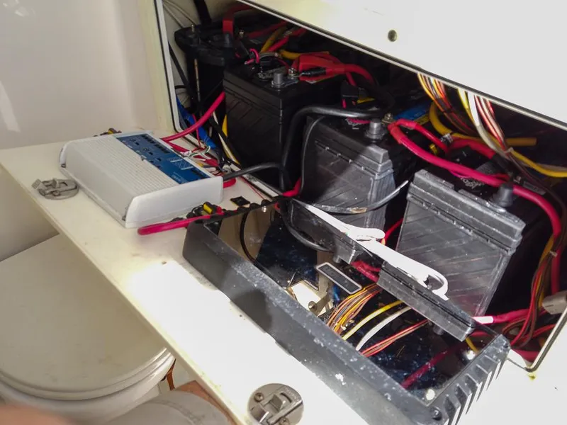 Slide: The Image of Electrical system of a 2015 Edgewater 320CC boat, featuring batteries and wiring. - 21