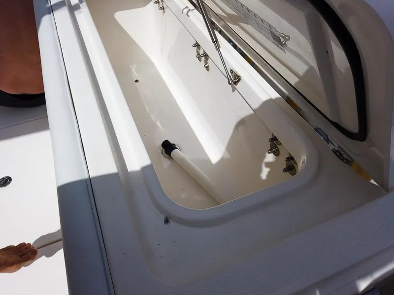 Slide: The Image of Open storage compartment on a 2015 Edgewater 320CC boat. - 23