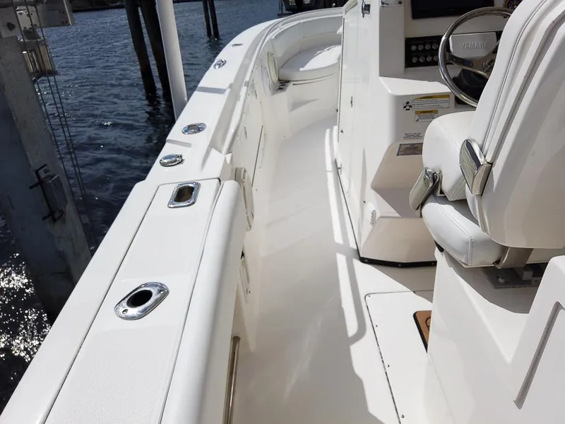 Slide: The Image of 2015 Edgewater 320CC boat interior with white seating and control panel. - 24