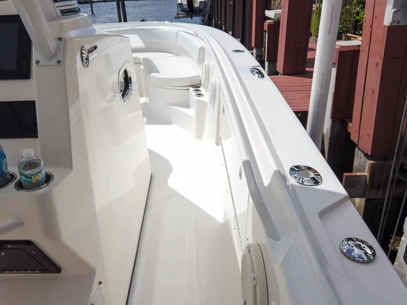 Slide: The Image of 2015 Edgewater 320CC boat interior with sleek white design and cup holders. - 25