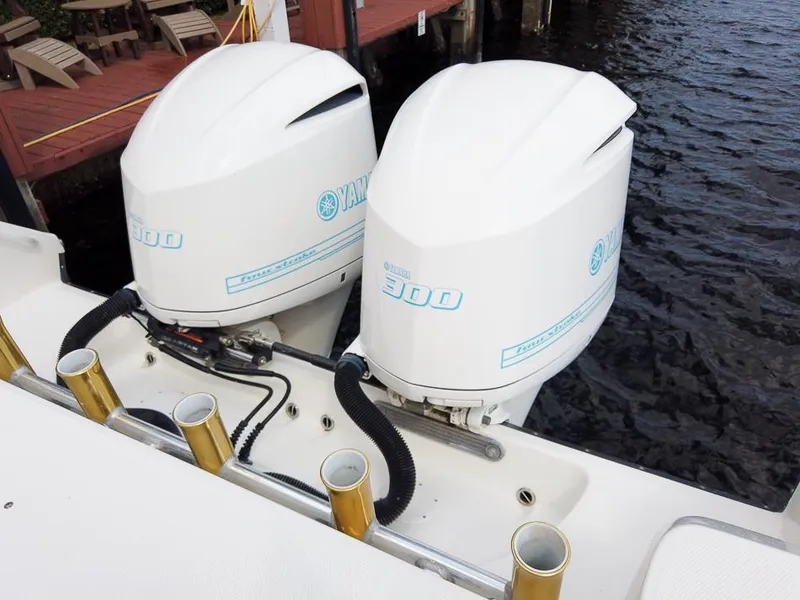 Slide: The Image of Twin Yamaha 300 outboard engines on a 2015 Edgewater 320CC boat by the dock. - 26