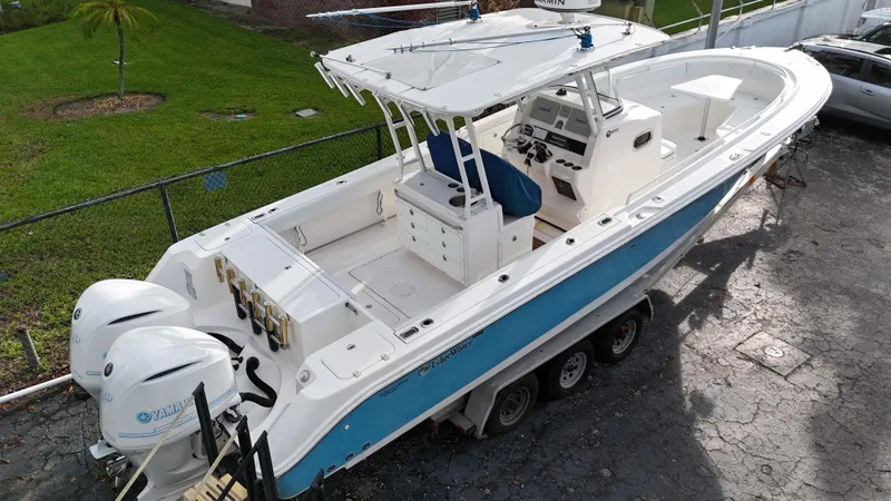 Slide: The Image of 2015 Edgewater 320CC boat with dual Yamaha engines on a trailer. - 3