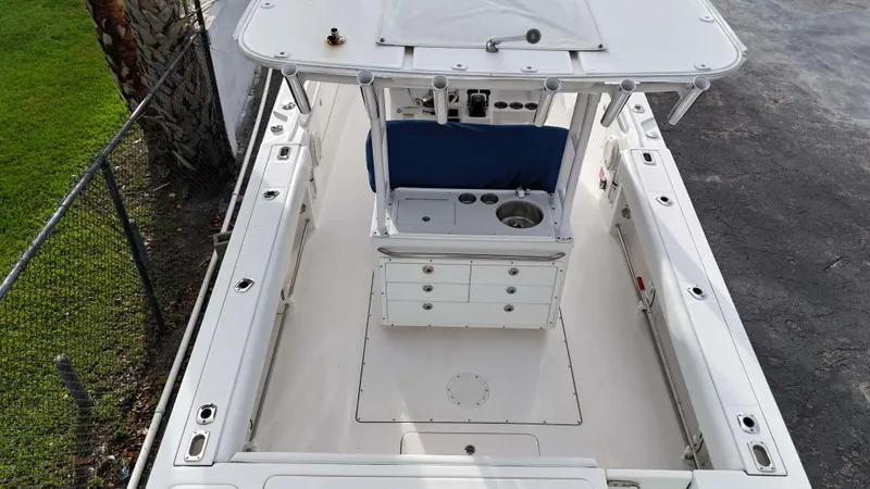 Slide: The Image of 2015 Edgewater 320CC boat interior, featuring spacious deck and center console. - 5