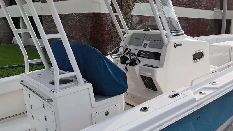 Slide: The Image of 2015 Edgewater 320CC boat cockpit with covered seat and Garmin navigation system. - 6