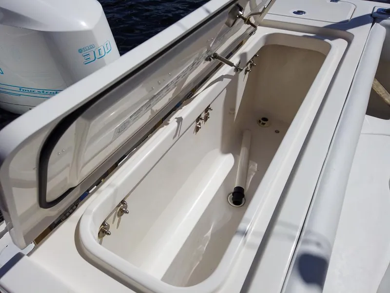 Slide: The Image of Open storage compartment on 2015 Edgewater 320CC boat with Yamaha 300 engine. - 8