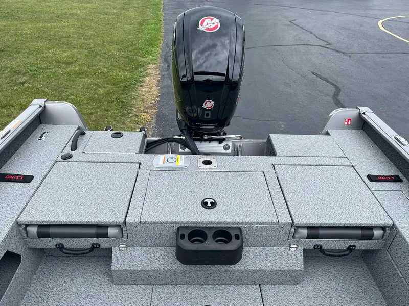 Slide: The Image of 2026 Lund 1775 Impact XS Sport boat with outboard motor, gray deck, and storage compartments. - 11