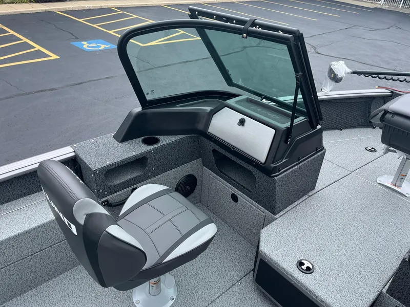 Slide: The Image of 2026 Lund 1775 Impact XS Sport boat interior with seating and windshield. - 14