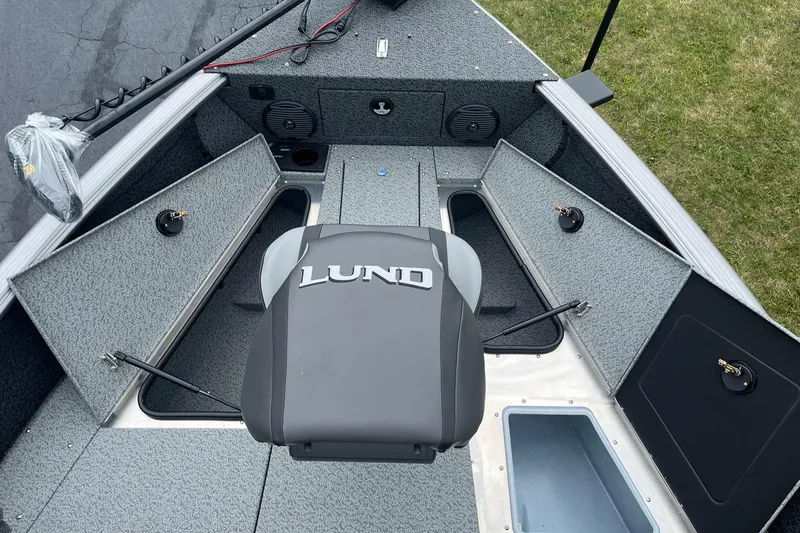 Slide: The Image of 2026 Lund 1775 Impact XS Sport boat interior with storage compartments and seating. - 17