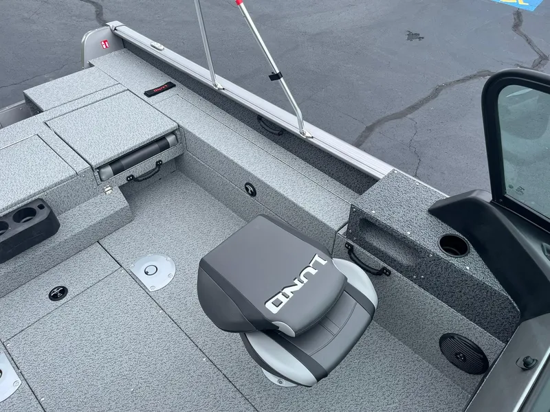 Slide: The Image of 2026 Lund 1775 Impact XS Sport boat interior with gray seating and storage compartments. - 18