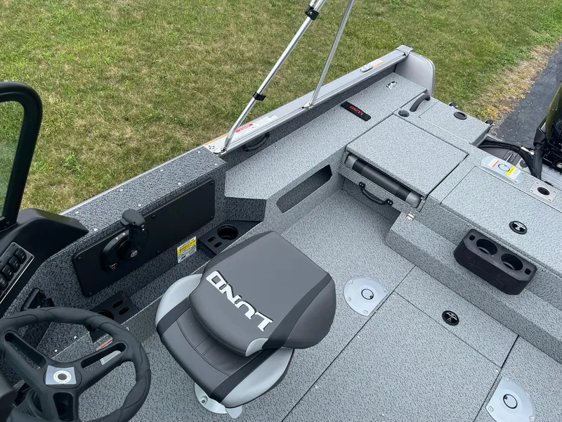 Slide: The Image of 2026 Lund 1775 Impact XS Sport boat interior with steering wheel and seating. - 19