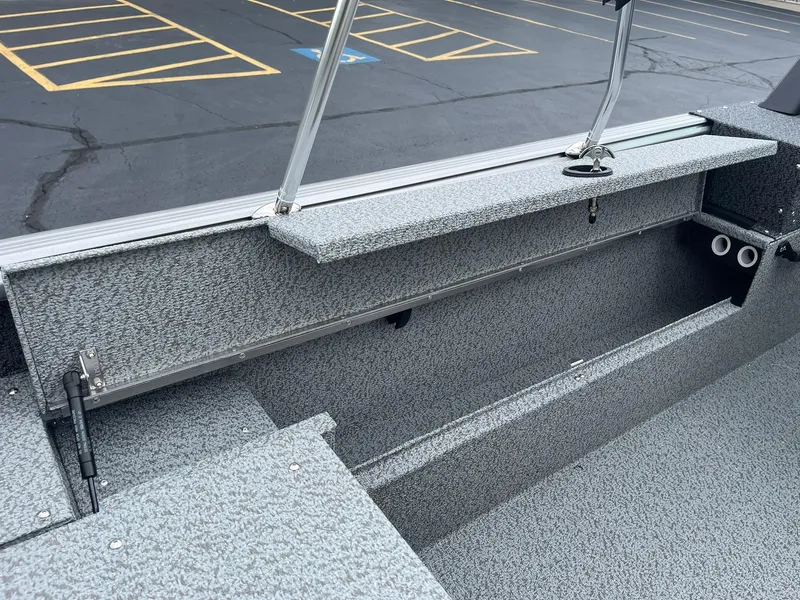 Slide: The Image of 2026 Lund 1775 Impact XS Sport boat interior with storage compartments and rod holders. - 21