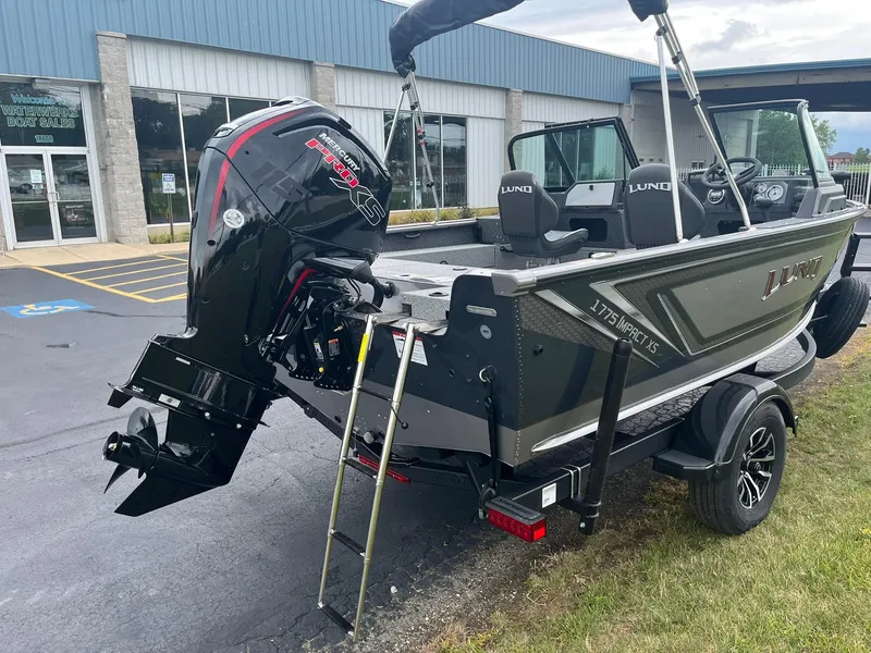 Slide: The Image of 2026 Lund 1775 Impact XS Sport boat with Mercury Pro XS engine, parked outside dealership. - 4