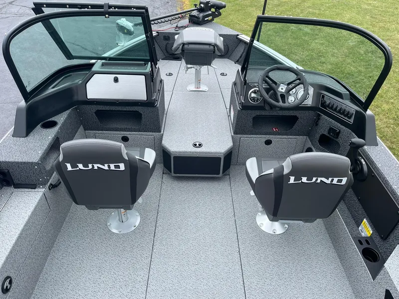 Slide: The Image of 2026 Lund 1775 Impact XS Sport boat interior with dual seats and steering console. - 8