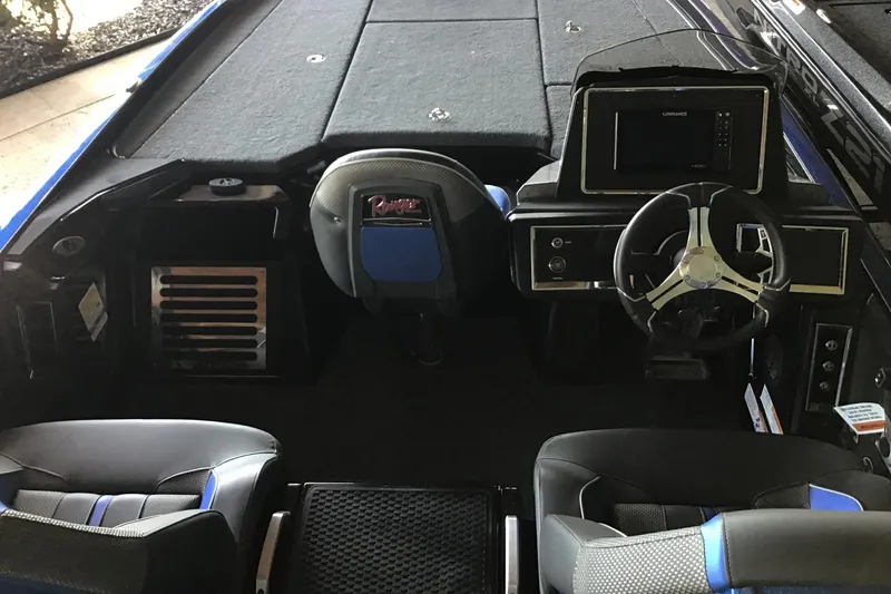 Slide: The Image of 2024 Ranger Z521R boat interior with steering wheel and control panel. - 2