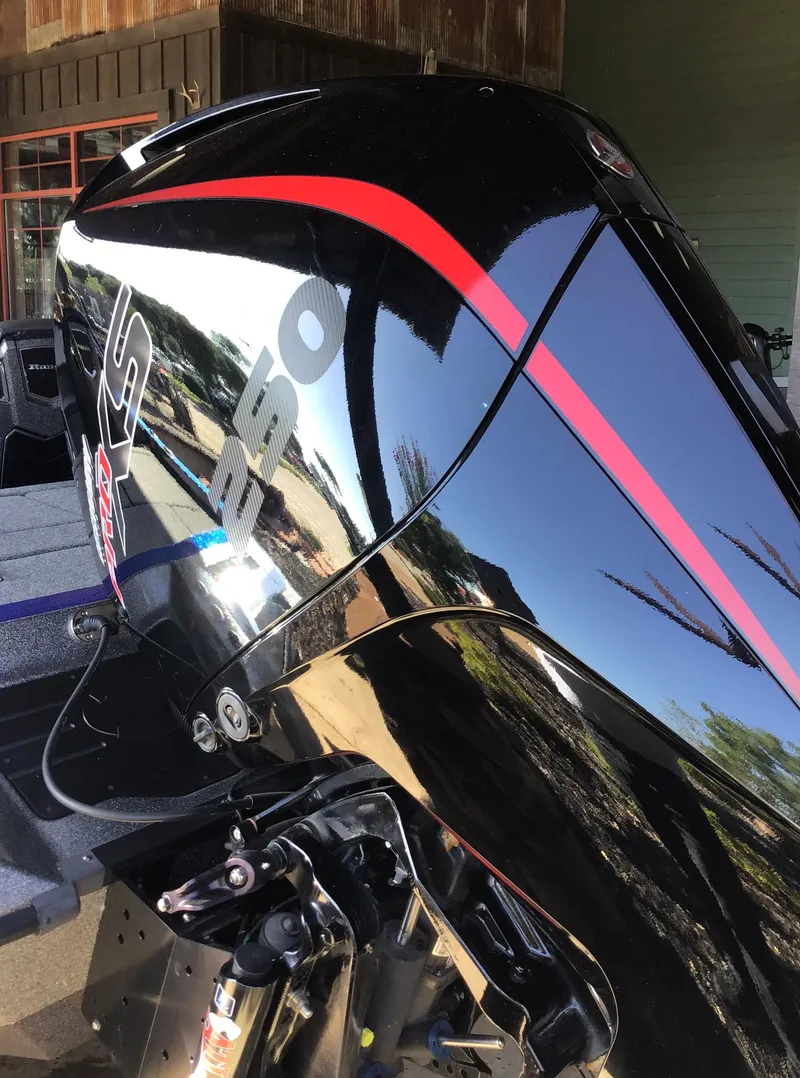 Slide: The Image of 2024 Ranger Z521R boat engine with sleek black and red design. - 3