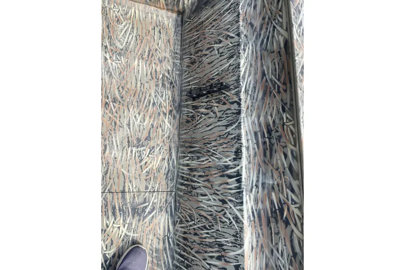 Slide: The Image of 2025 Tracker Grizzly 2072 CC boat interior with camouflage pattern design. - 10