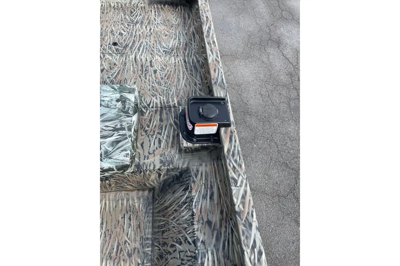 Slide: The Image of 2025 Tracker Grizzly 2072 CC boat interior with camouflage pattern and equipment. - 12