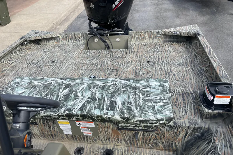 Slide: The Image of 2025 Tracker Grizzly 2072 CC boat with camouflage interior and outboard motor. - 13