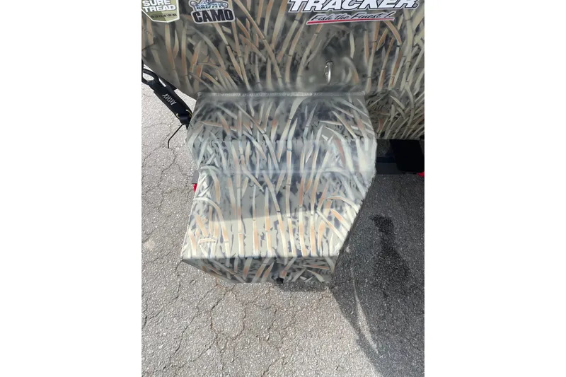 Slide: The Image of 2025 Tracker Grizzly 2072 CC boat with camouflage design on pavement. - 7