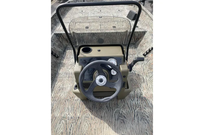 Slide: The Image of 2025 Tracker Grizzly 2072 CC boat console with steering wheel and controls. - 8