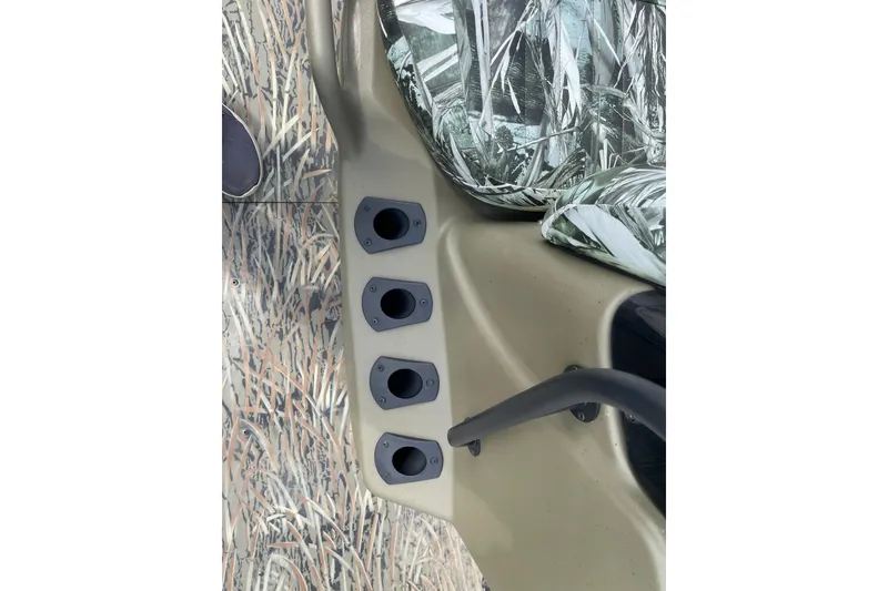 Slide: The Image of Interior view of 2025 Tracker Grizzly 2072 CC boat with camo seating and control panel. - 9