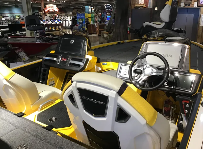 Slide: The Image of 2025 Ranger Z520R Cup-Equipped boat interior with yellow accents and advanced controls. - 2