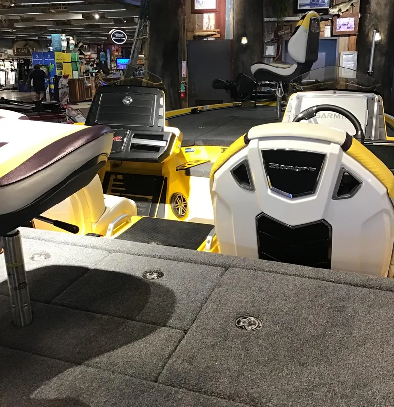 Slide: The Image of 2025 Ranger Z520R Cup-Equipped boat interior with seating and equipment in showroom. - 3