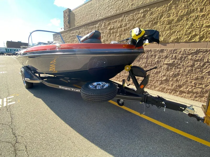 Slide: The Image of 2025 Ranger 1850MS boat on trailer, parked outdoors, sunny day. - 2
