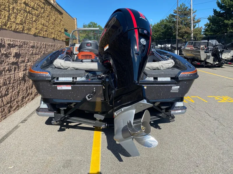 Slide: The Image of 2025 Ranger 1850MS boat with powerful outboard motor, parked outdoors on a sunny day. - 3