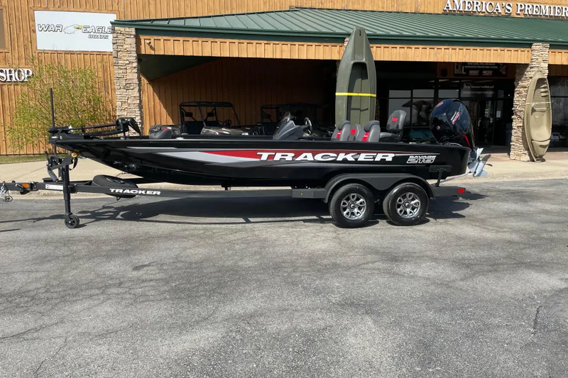 The Image of 2025 Tracker Savage 215 boat on trailer, parked outside a dealership. - 0