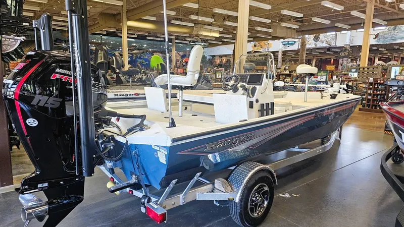 Slide: The Image of 2025 Ranger RB190 boat displayed indoors with Mercury Pro XS engine. - 11