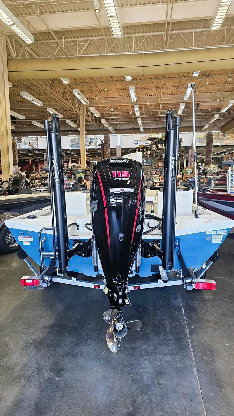 Slide: The Image of 2025 Ranger RB190 boat with Mercury 115 engine displayed indoors. - 12