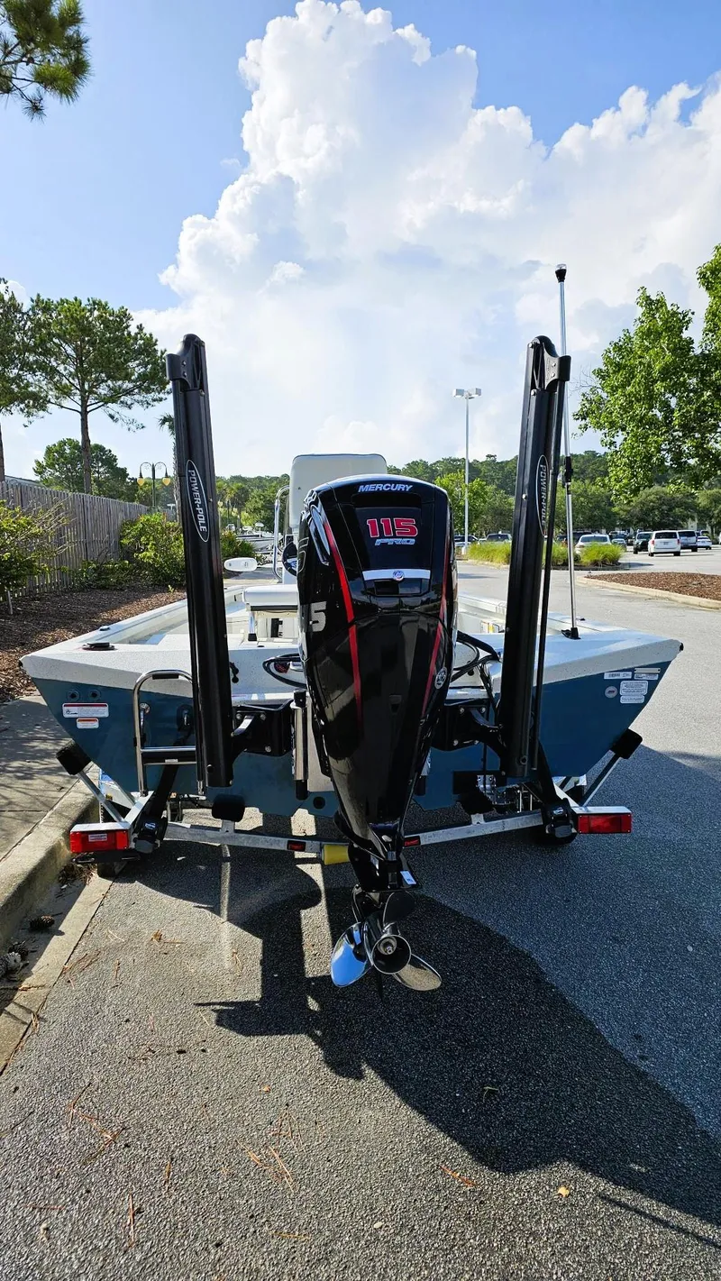 Slide: The Image of 2025 Ranger RB190 boat with Mercury 115 engine, parked outdoors under a blue sky. - 3