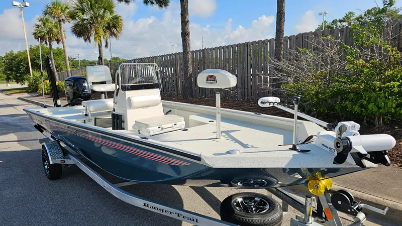 Slide: The Image of 2025 Ranger RB190 boat on trailer, parked outdoors, sunny day. - 6