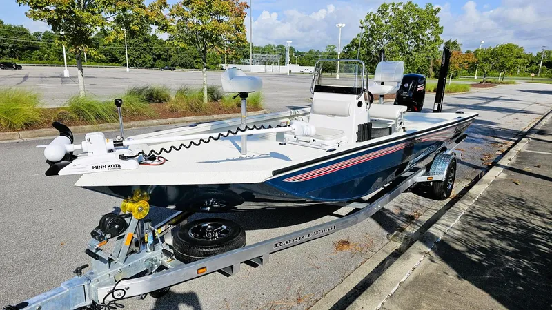 Slide: The Image of 2025 Ranger RB190 boat on trailer in parking lot, featuring Minn Kota trolling motor. - 7