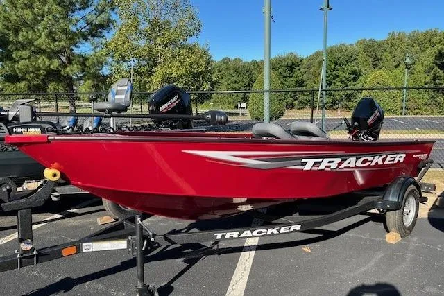 The Image of 2025 Tracker Super Guide V-16 SC boat in vibrant red on a trailer. - 0