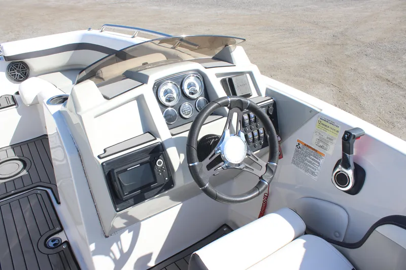 Slide: The Image of 2021 Starcraft SVX 191 OB boat dashboard with steering wheel and controls. - 13